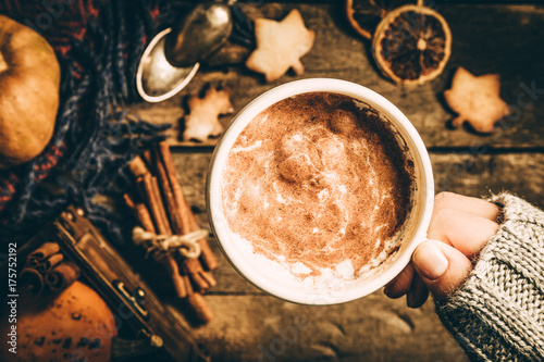 Autumn pumpkin spice latte on rustic wood background