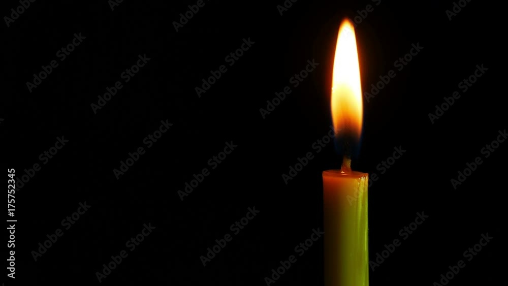 Close up candle is burning on black background. Close up candle is burning on black background.
