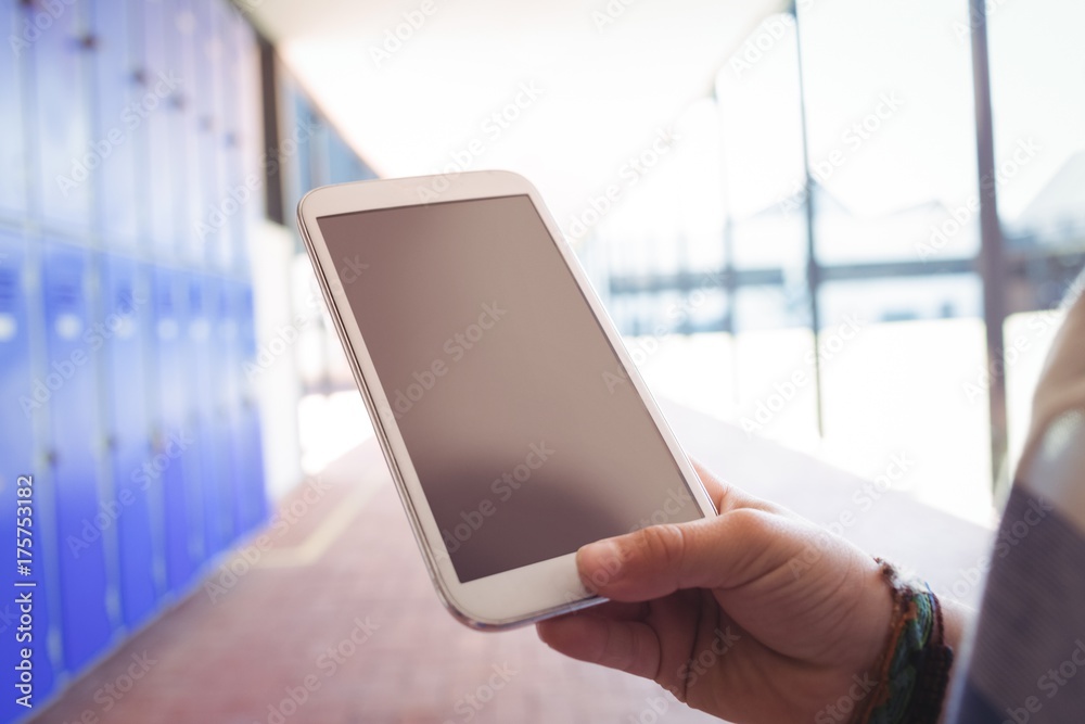 Cropped hand on student using mobile phone Cropped hand on student using mobile phone