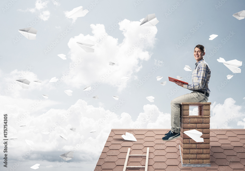 Handsome student guy reading book and paper planes flying in air Handsome student guy reading book and paper planes flying in air