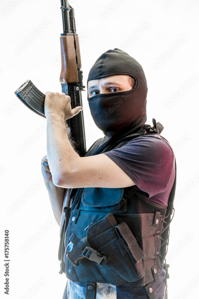Thief, man armed with balaclava and bulletproof vest, gun and shotgun, kalashnikov Thief, man armed with balaclava and bulletproof vest, gun and shotgun, kalashnikov