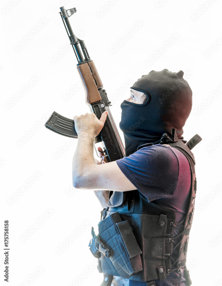 Criminal man armed with balaclava and bulletproof vest, gun and shotgun, kalashnikov Criminal man armed with balaclava and bulletproof vest, gun and shotgun, kalashnikov