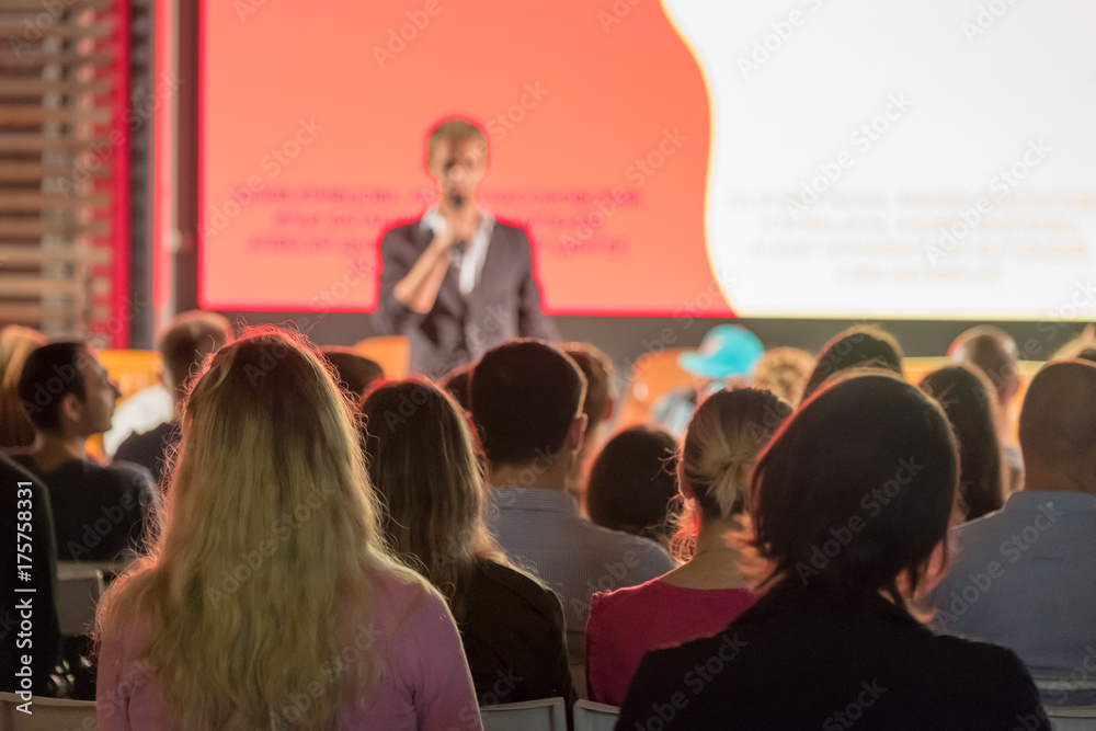 Audience listens to the lecturer at the conference hall