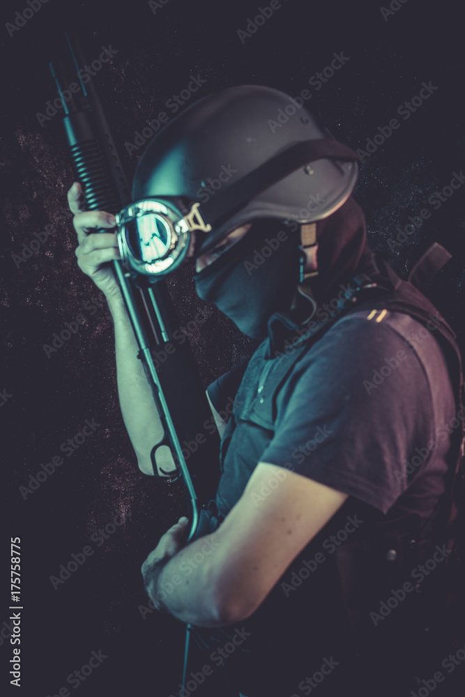 Man in mask holding rifle against white background