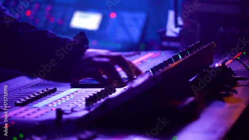 View in motion of sound engineer working on his workplace