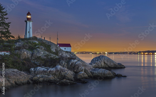 Point Atkinson Lighthouse at mouth of Howe Sound in West Vancouver Urban Park with Distant Burrard Strait and UBC Sunset City Lights Panorama Landscape  photo
