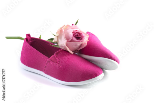 pink kid shoes and a rose isolated on a white background, concept International Day of the Girl Child on 11 October, copy space