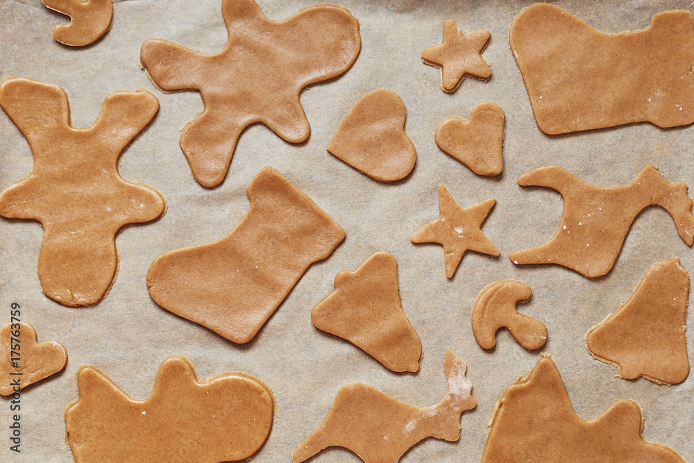 Homemade gingerbread cookies, forms and baking ingredients.