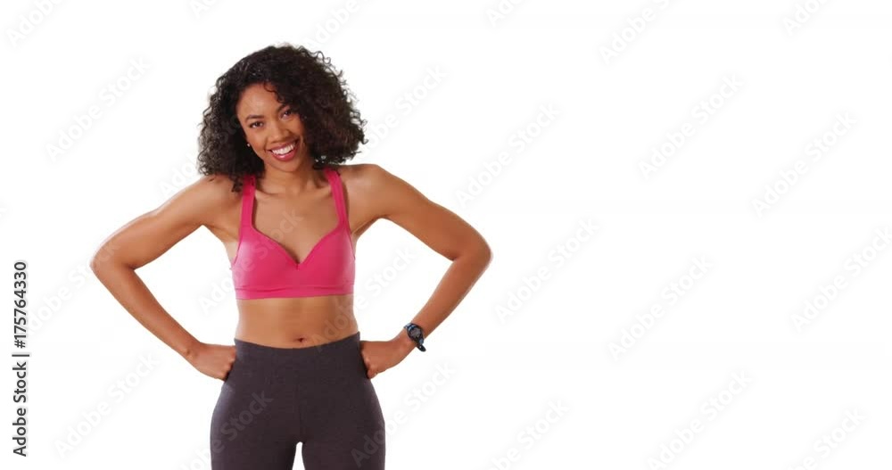 Cute black female with toned arms on left of screen laughing at camera in studio Cute black female with toned arms on left of screen laughing at camera in studio