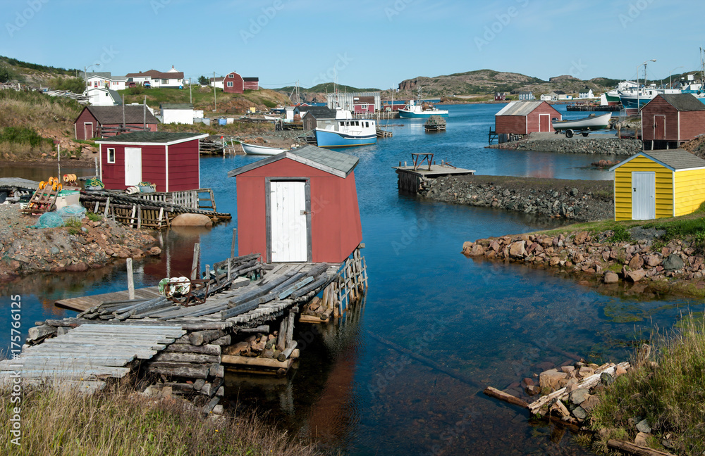 Newfoundland Fishing Village:  Fishing shanties sit on rustic wooden piers and rock jetties that extend into a small harbor on the north coast of Newfoundland.