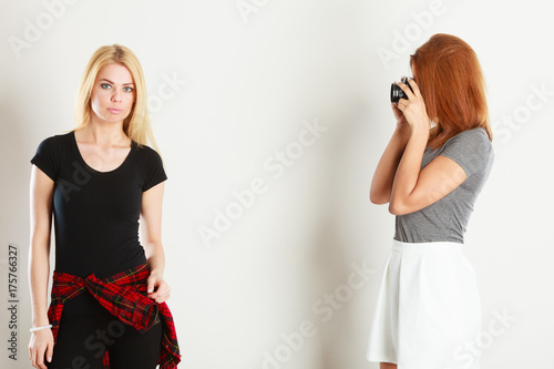girl photographing blonde woman