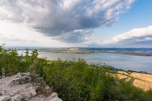 Wallpaper Mural Landscape of village from castle on hill. Lake in foreground. Dramatic sky. Torontodigital.ca