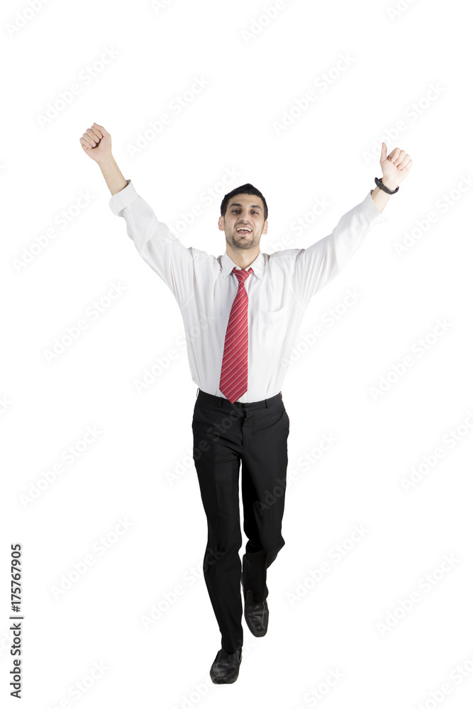 Successful Arabian businessman running on studio Successful Arabian businessman running on studio