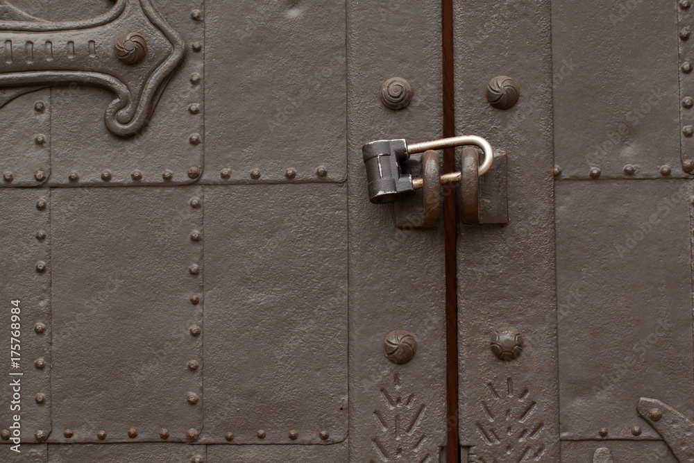 beautiful antique metal door with padlock, very sturdy and reliable