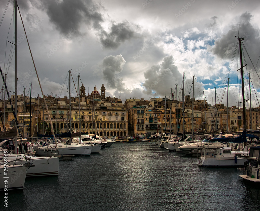 Birgu. Kalkara. Bormla. Boat mooring. Yachts. Clouds over Valletta. Malta.