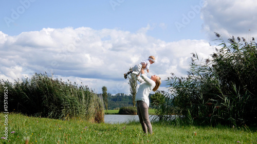 Mom plays with daughter on lawn