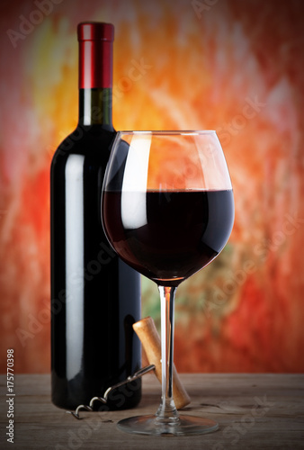 bottle and a wine glass with red wine