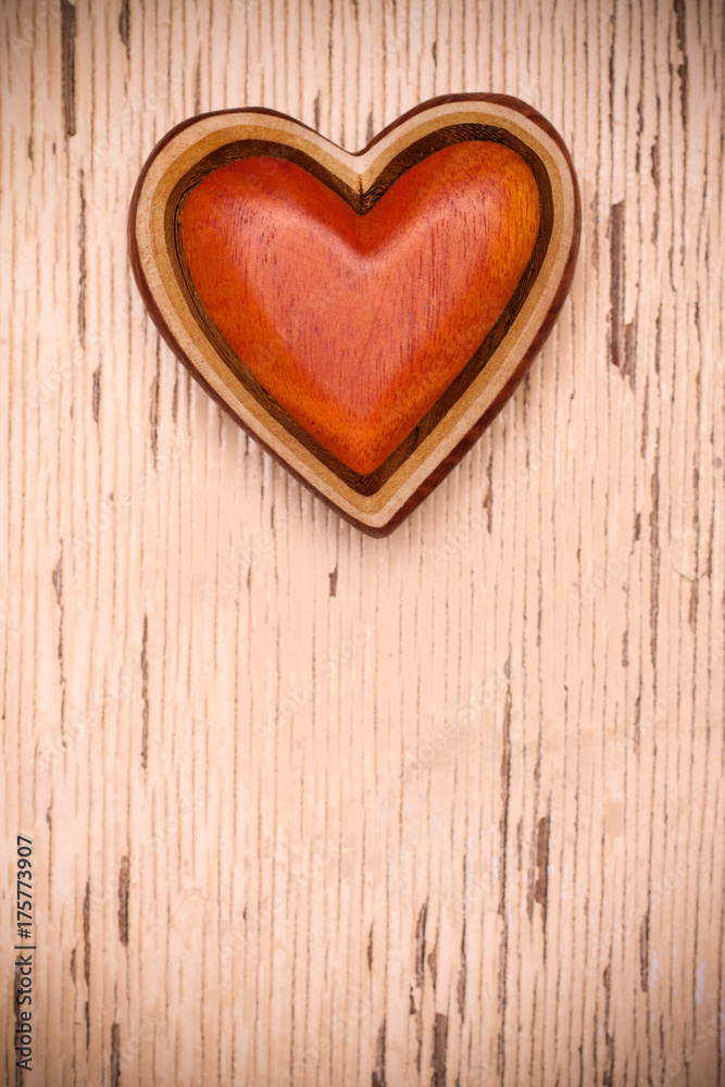 One wooden heart on rustic wood background. Valentines days concept. Love symbol. Greeting card with copy space. One wooden heart on rustic wood background. Valentines days concept. Love symbol. Greeting card with copy space.