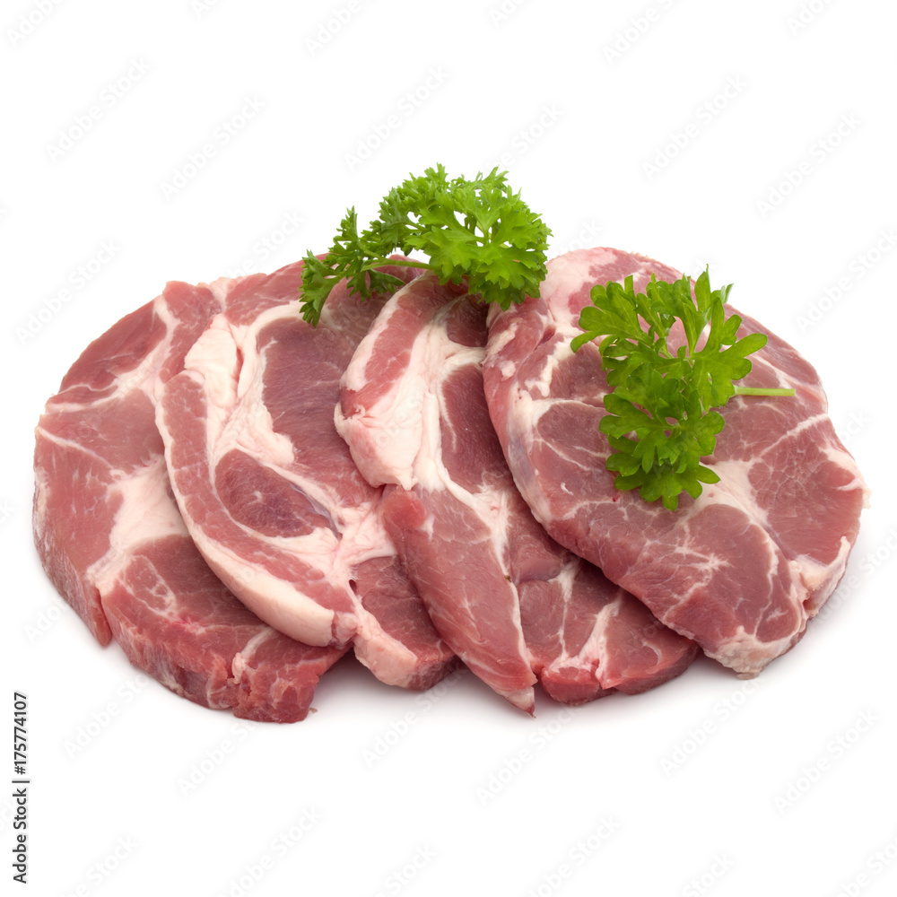 Raw pork neck chop meat with parsley herb leaves garnish isolated on white background cutout Raw pork neck chop meat with parsley herb leaves garnish isolated on white background cutout