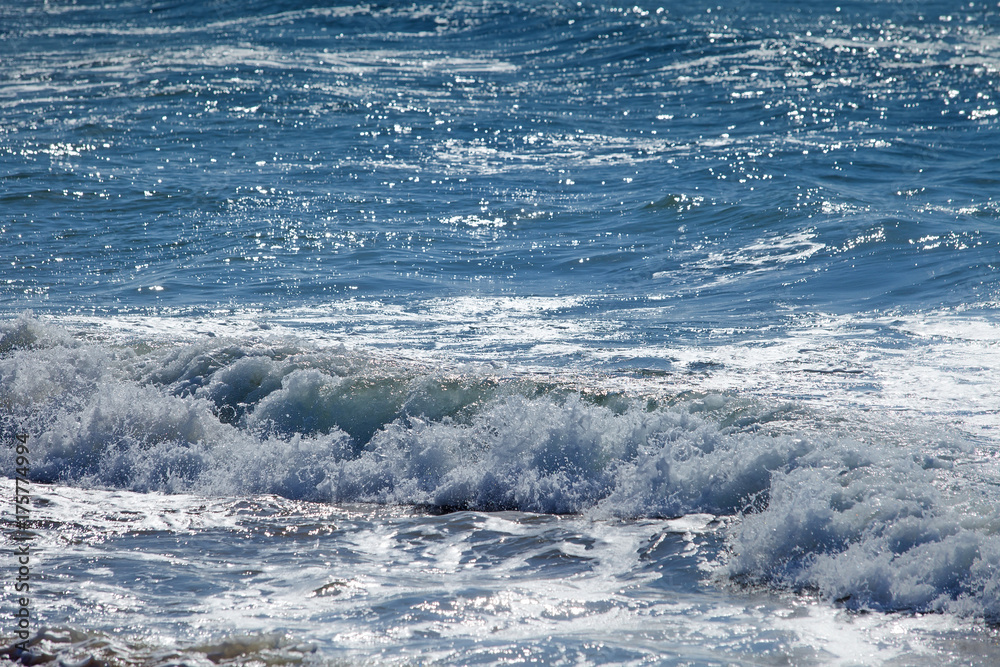 Fototapeta premium Wave of blue ocean on sandy beach. Background.