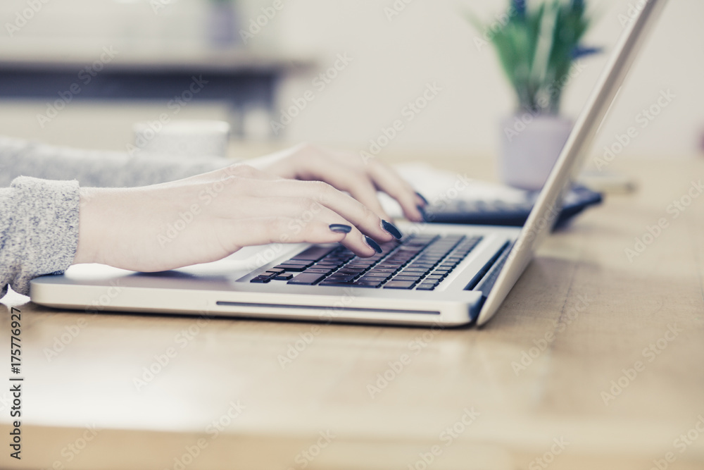 Young business woman, typing on notebook Young business woman, typing on notebook