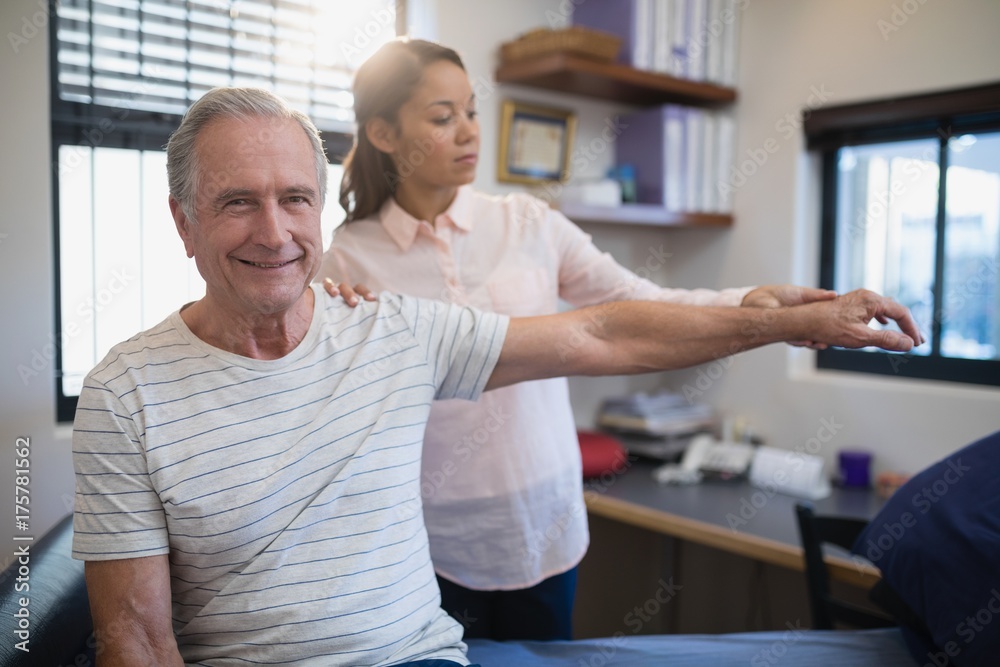 Portrait of smiling senior male patient with female doctor Portrait of smiling senior male patient with female doctor