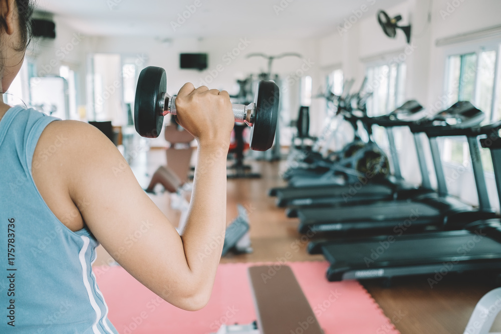 Woman exercising with dumbbell. Woman exercising with dumbbell.