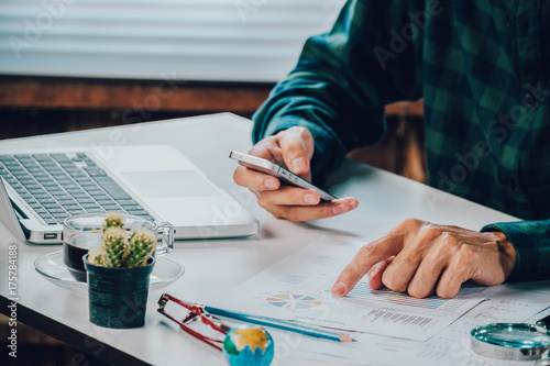 Businessman hand working with business graph or analysis chart photo