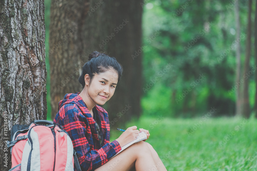 Hipster young girl with backpack reading book Hipster young girl with backpack reading book