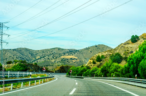 Fast road in the mountains in Spain, beautiful landscape of mountains, dry earth and rock from the sun