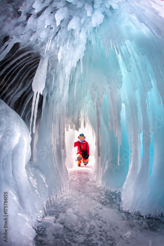 Man between the ice rocks on Lake Baikal on a clear day