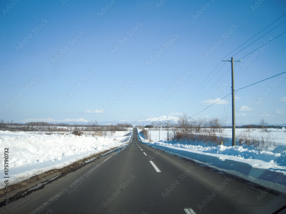 冬の道東の一本道と知床連山の遠望（北海道）