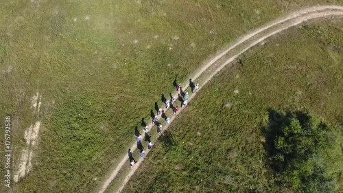 AERO: Cap tourists hiking mountain trail with backpacks Aerial view ftourists mountains look mountain beautiful landscape autentic view couple trekking walking backpacks trail tourism Crimea Russia 4K photo