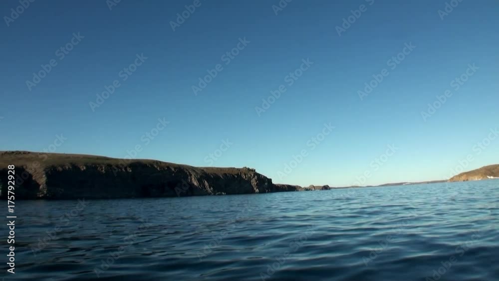 Coast and water surface of Arctic Ocean on New Earth Vaigach Island. Beautiful landscape of wild nature. Quiet and calm ecotourism in Russia. Panorama of way to cold wilderness. Coast and water surface of Arctic Ocean on New Earth Vaigach Island. Beautiful landscape of wild nature. Quiet and calm ecotourism in Russia. Panorama of way to cold wilderness.