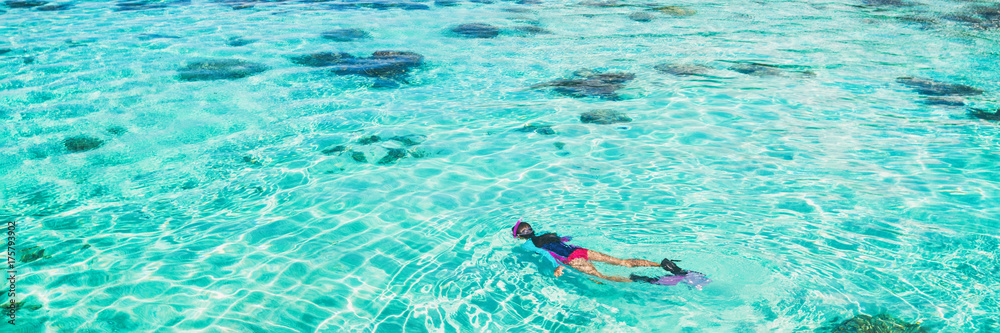 Vacation tourist snorkel woman swimming snorkeling in paradise clear water banner panorama. Swim girl snorkeler in crystalline waters and coral reefs. Turquoise ocean background.