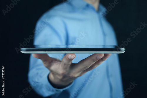 Businessman holding digital tablet.