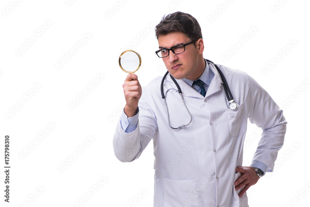 Young male doctor with a looking magnifying glass isolated on wh Young male doctor with a looking magnifying glass isolated on wh