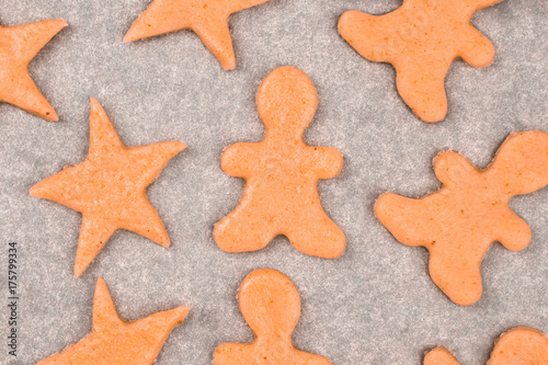 Christmas gingerbread cookies from fresh dough on baking paper: star, man