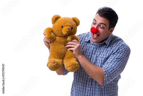 Funny clown man with a soft teddy bear toy isolated on white bac