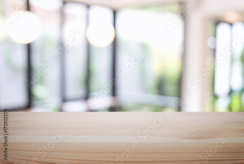 Empty wooden table and blur background of abstract in front of restaurant or coffee shop, cafe can be used Mock up for display of product or for montage