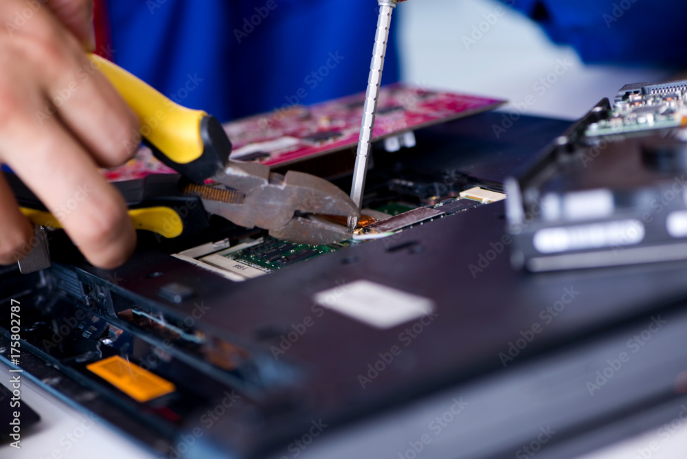 Naklejka premium Repairman working in technical support fixing computer laptop tr