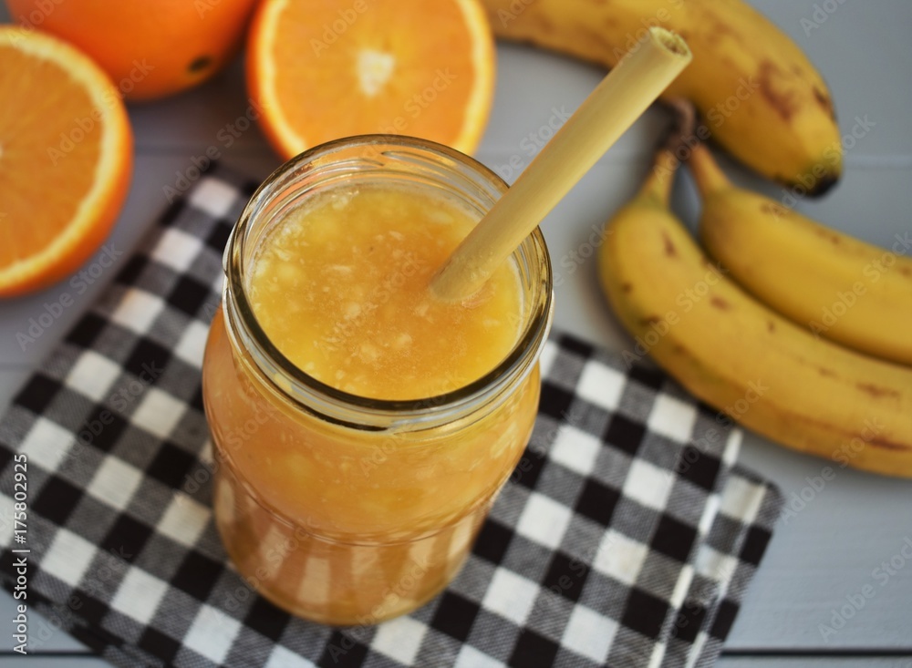 Banana and orange smoothie in jar. Banana and orange smoothie in jar.
