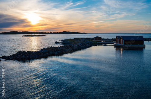 Slika na platnu Sun reflecting in the still water near the Jurmo island in Finnish archipelago