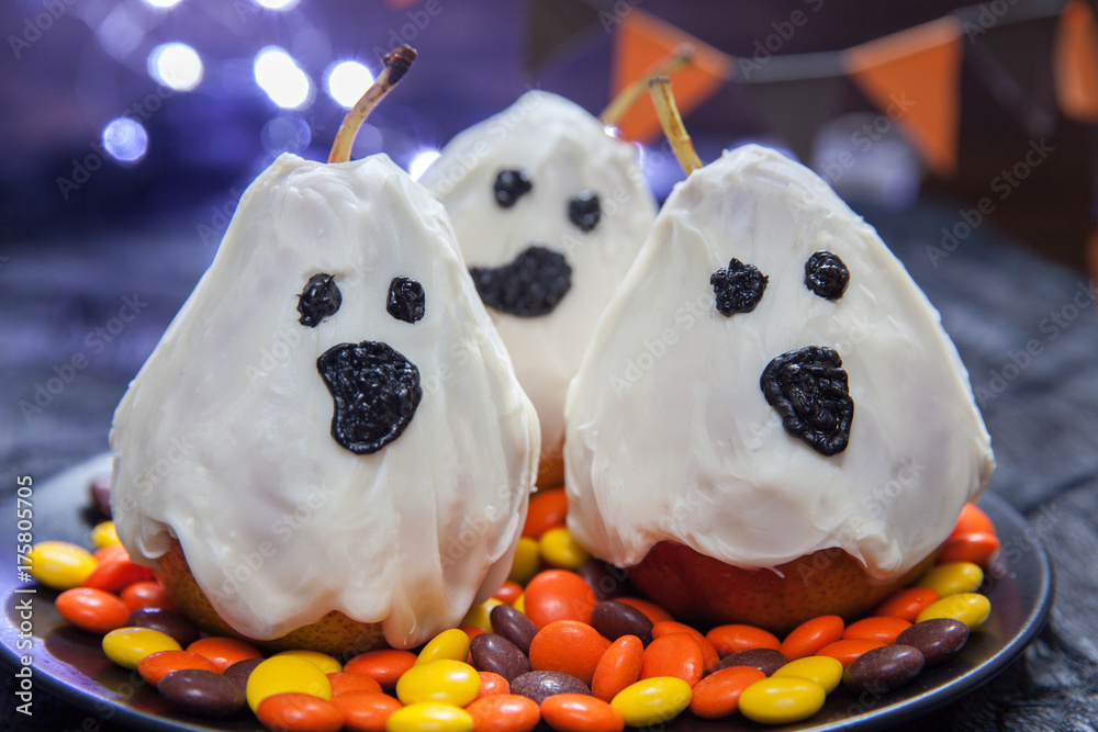 Halloween candy pears or white chocolate ghosts on a stick