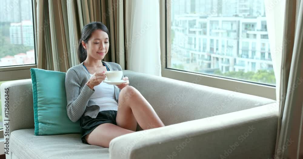 Woman watching the view out of window at home Woman watching the view out of window at home