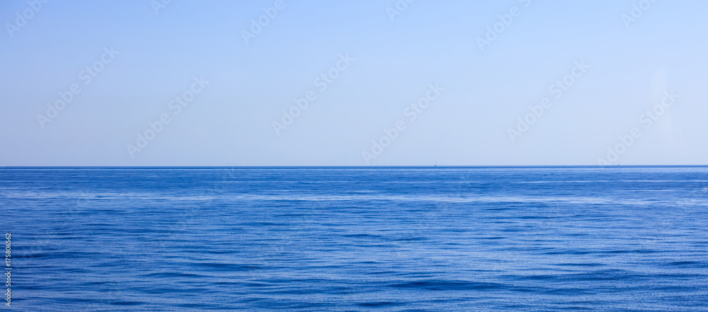 A view of calm sea and blue sky background,