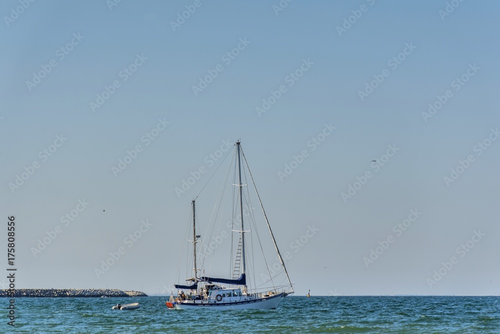 Classic white yachts anchored in the Black Sea .  Sailing a classic yacht on the Black Sea.Vintage sailboat anchored in turquoise water.