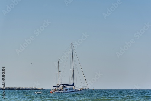 Classic white yachts anchored in the Black Sea . Sailing a classic yacht on the Black Sea.Vintage sailboat anchored in turquoise water.