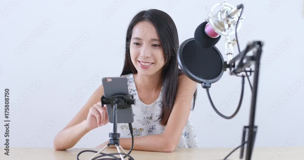 Woman having live stream on cellphone Woman having live stream on cellphone