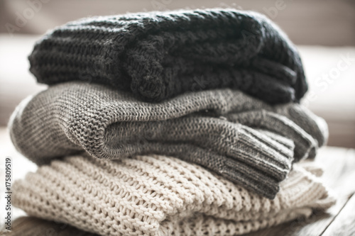 stack of cozy knitted sweaters